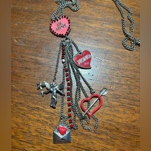 Valentine's Day themed necklace with various red and silver-toned Designs
